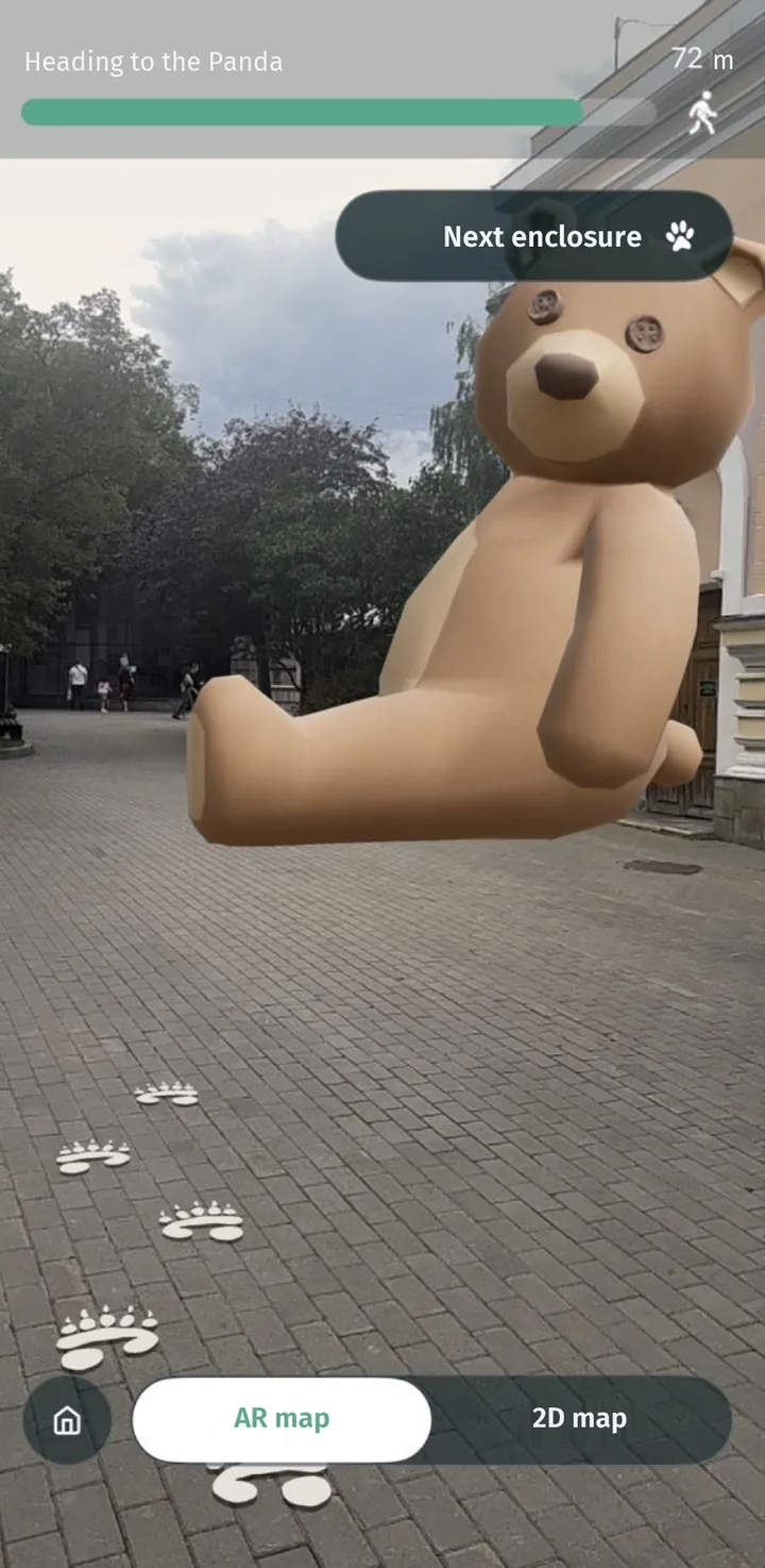 AR navigation at a zoo: a bear and paw prints lead to the panda enclosure, 72 m away
